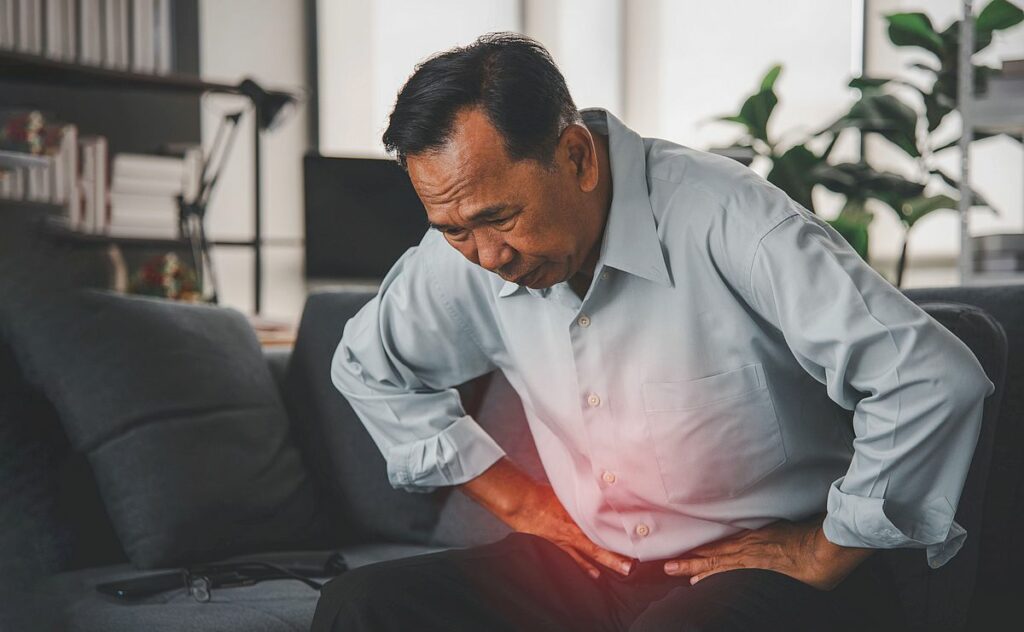man suffering from stomach pain